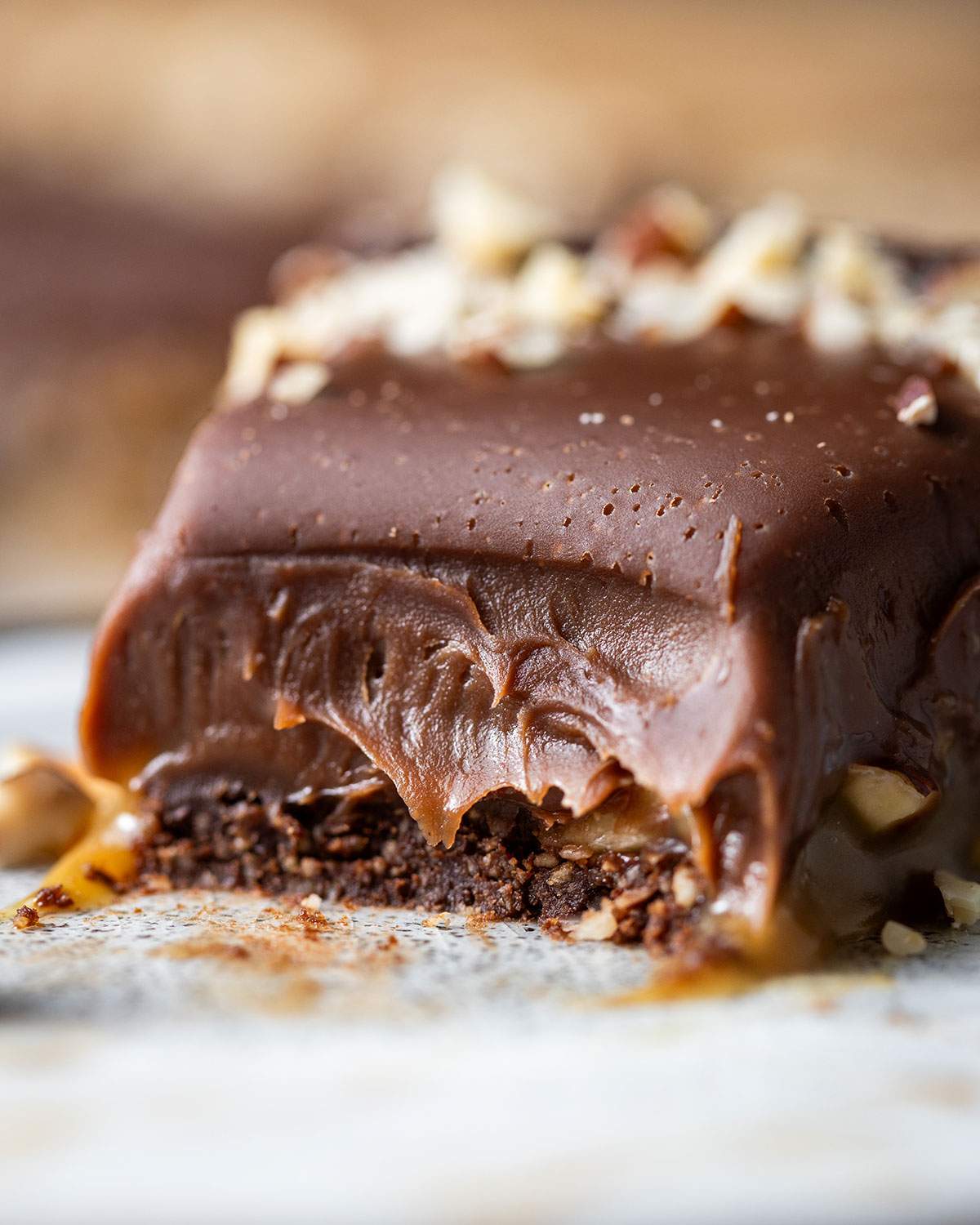 A slice of half-eaten decadent chocolate tart up close.