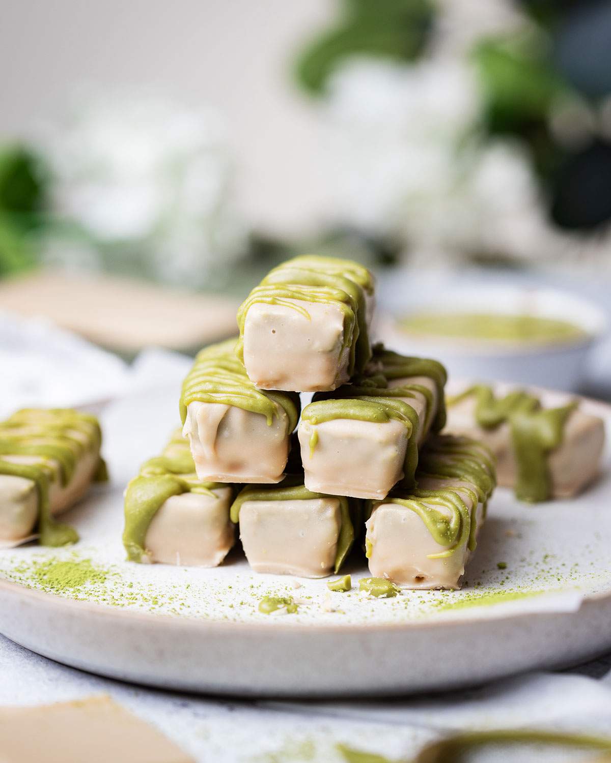 A stack of homemade matcha twix bars covered in white chocolate.