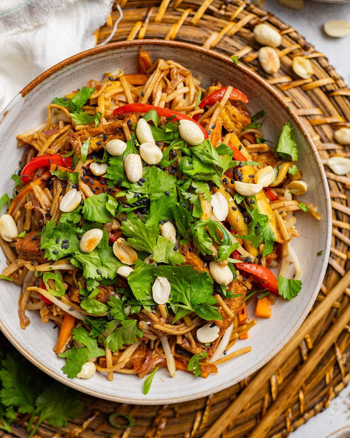 Healthy pad thai served in a bowl and garnished with peanuts and fresh coriander.