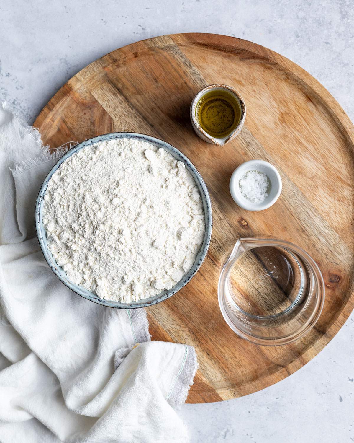 Ingredients for flatbread dough on a tray.