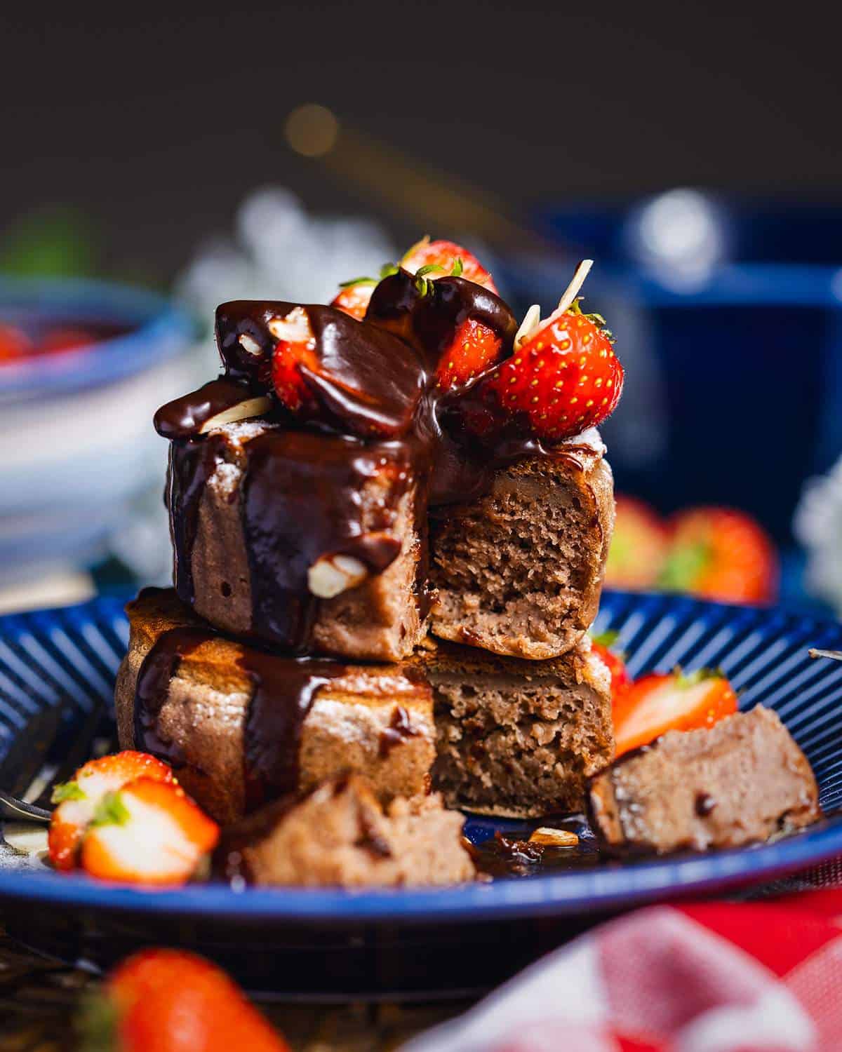 Stacked soufflé pancakes on a plate with a piece cut out of the stack showing the fluffy texture.