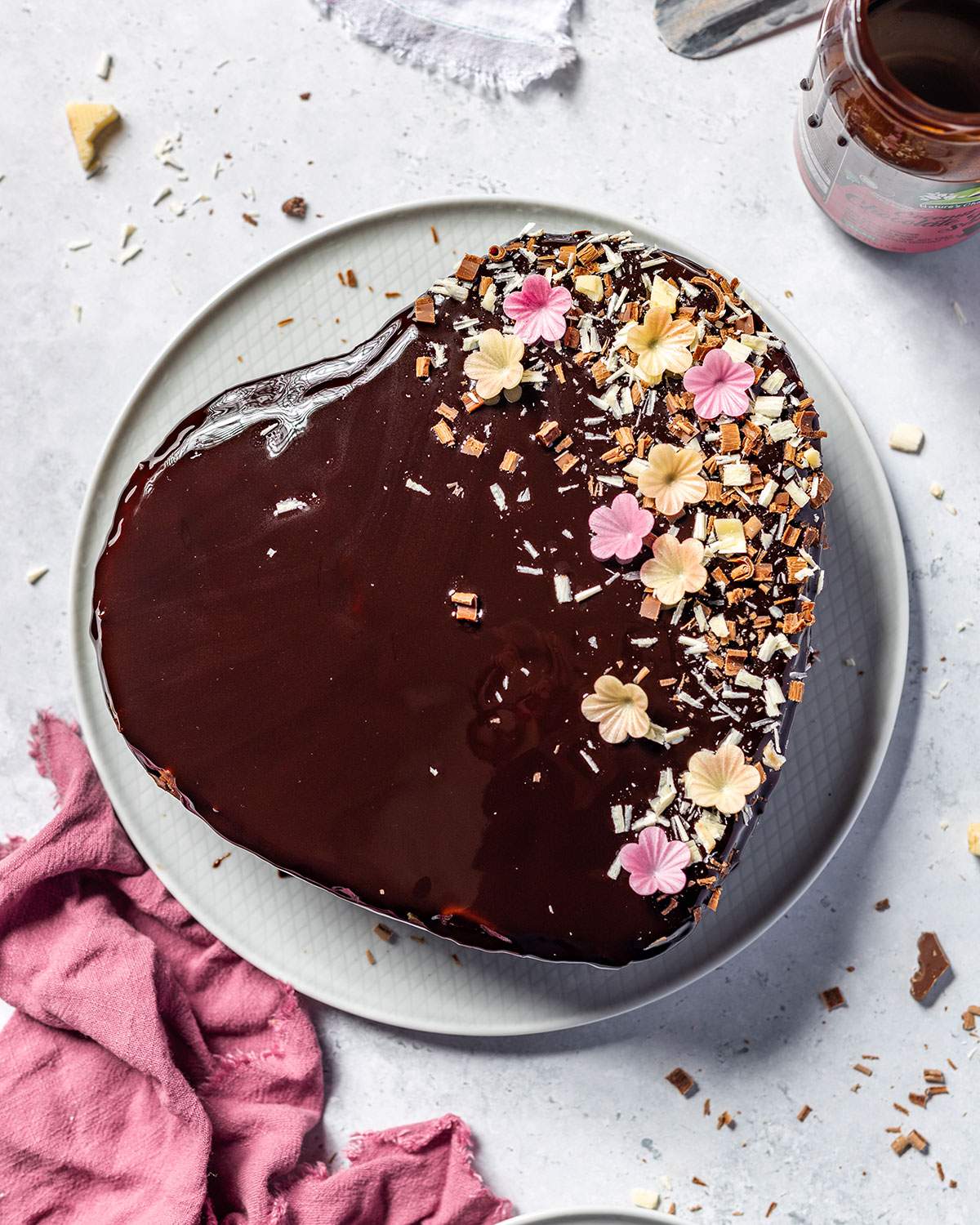 A heart-shaped chocolate cake on a serving platter.