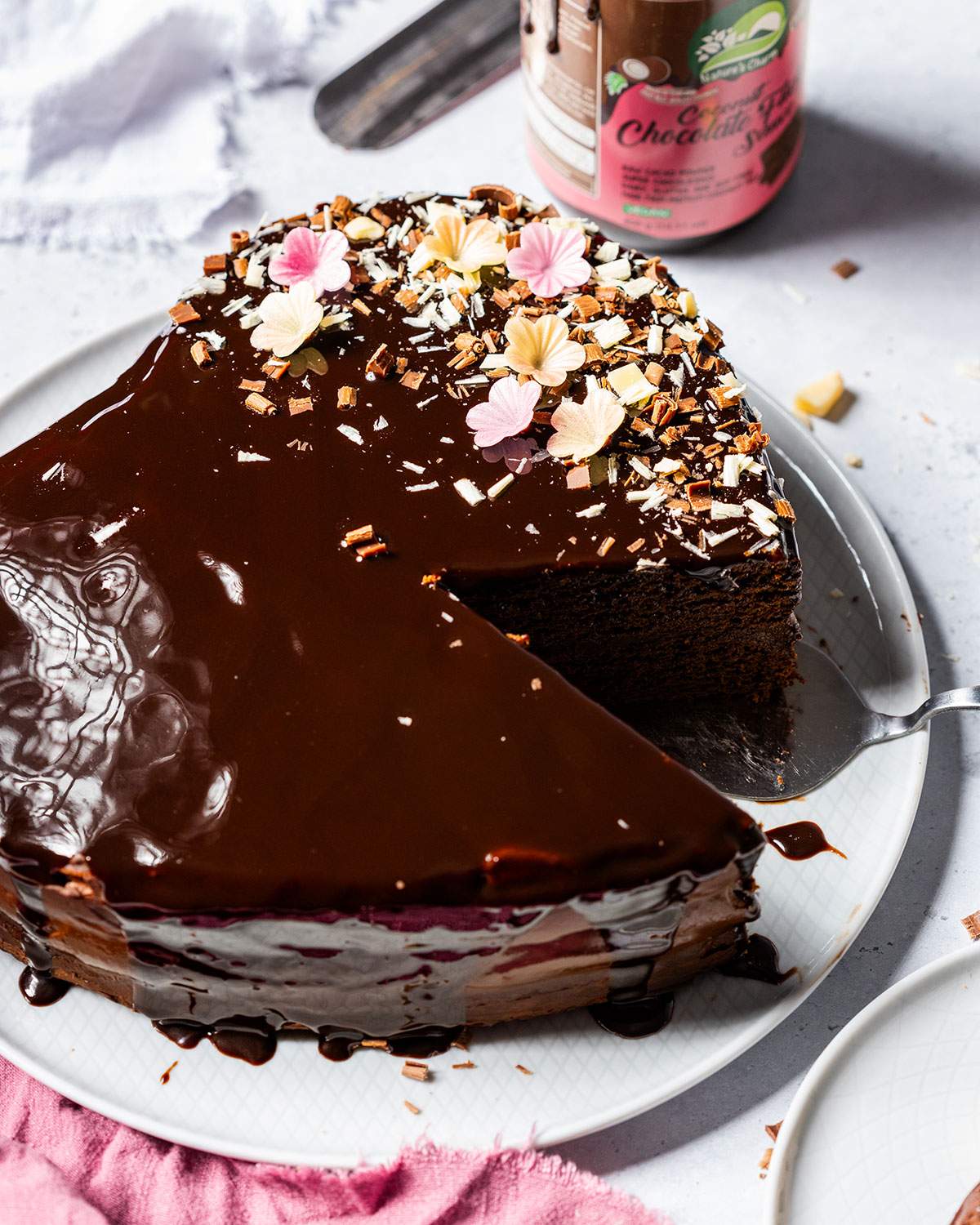 Avocado chocolate cake with a slice cut out of it.