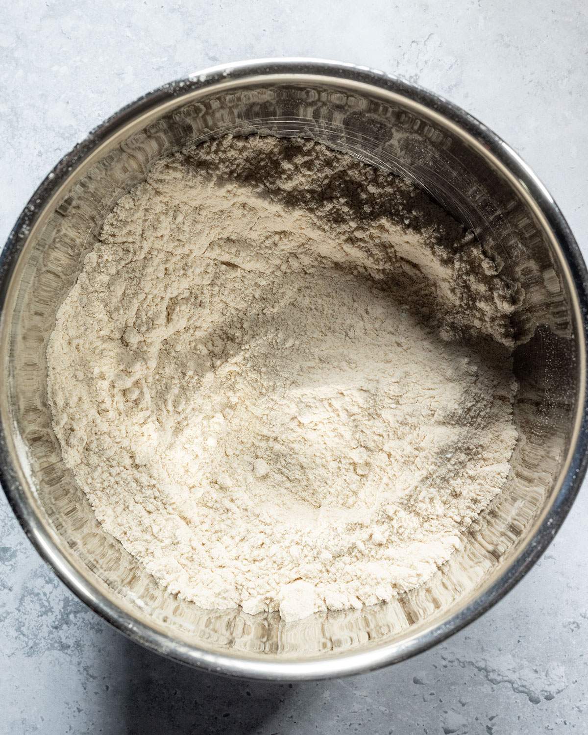 Dry ingredients for avocado cake in a mixing bowl.