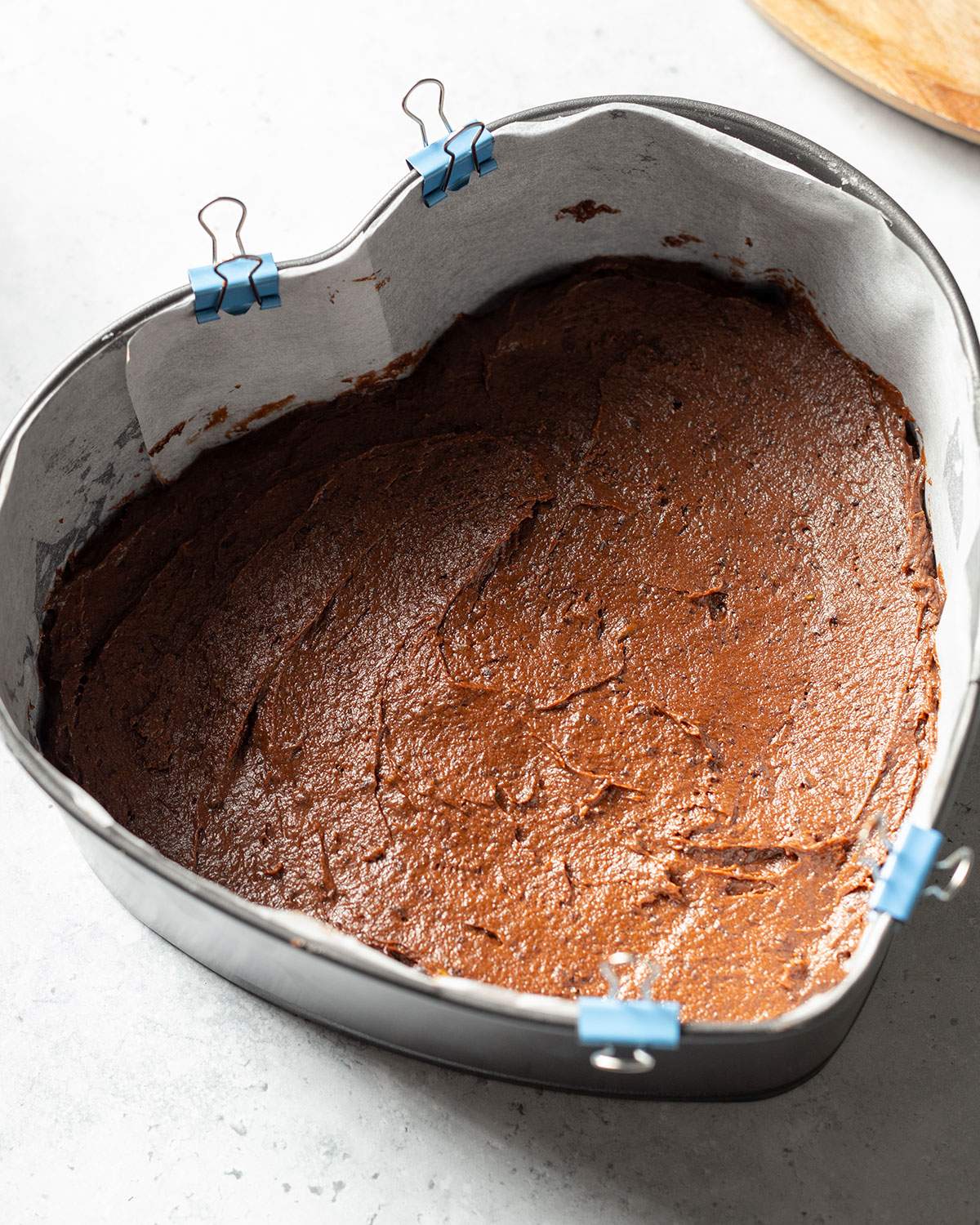 Avocado chocolate cake batter in a heart-shaped cake pan.