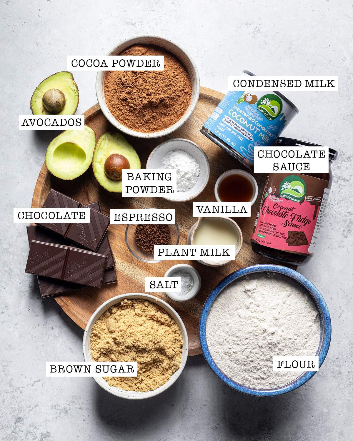 Ingredients for avocado chocolate cake on a tray with labels.