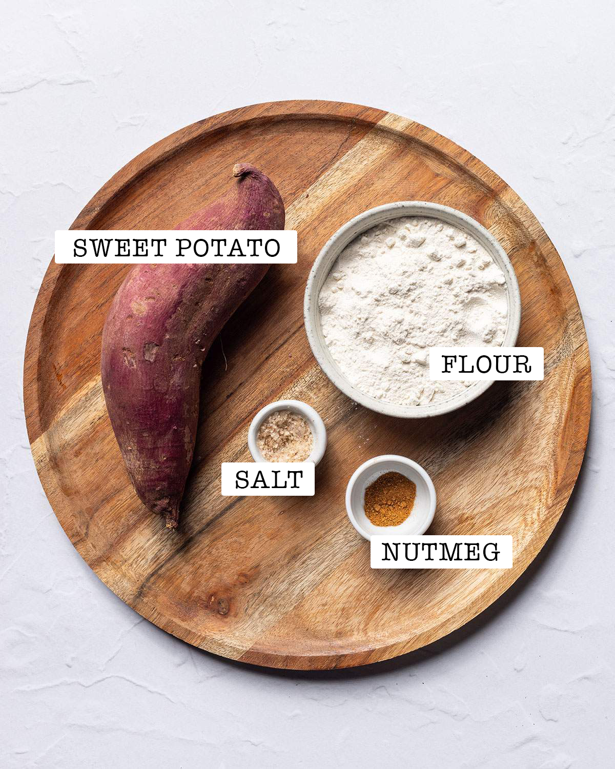 Ingredients for sweet potato gnocchi on a serving board, with labels.