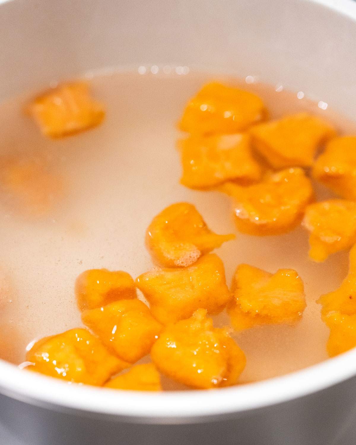 Simmering sweet potato gnocchi in salted water.