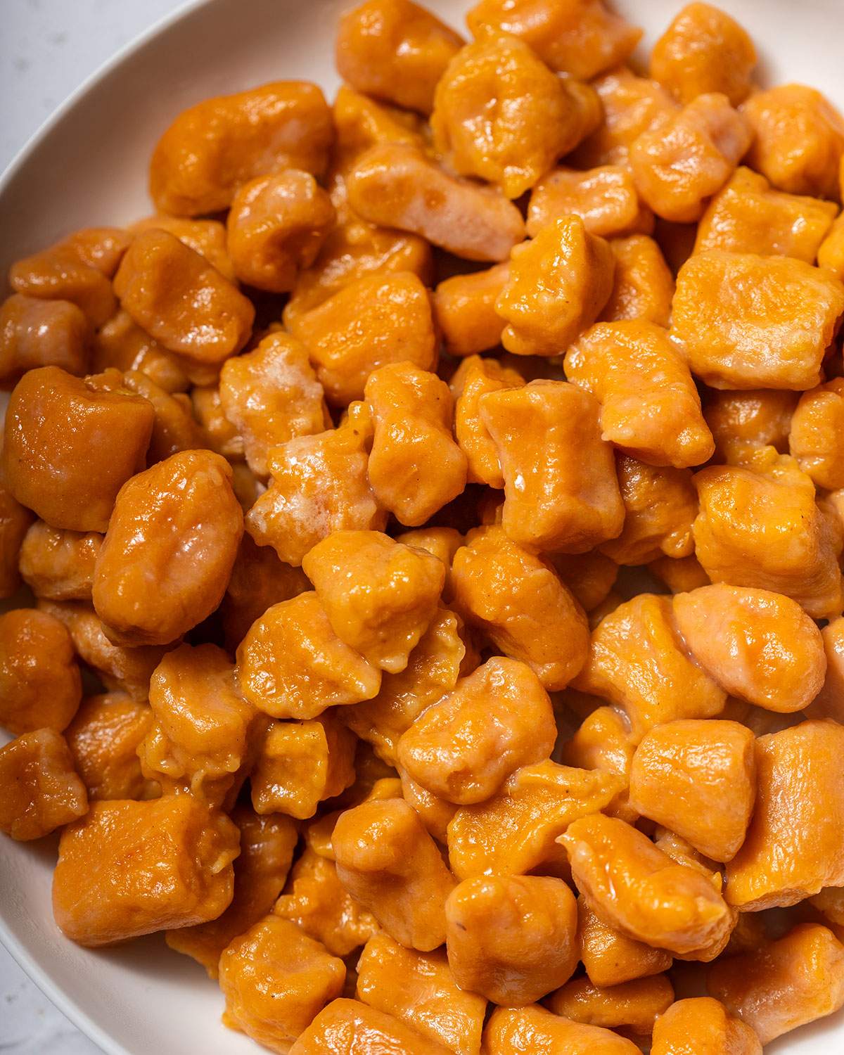 Freshly cooked sweet potato gnocchi on a plate.