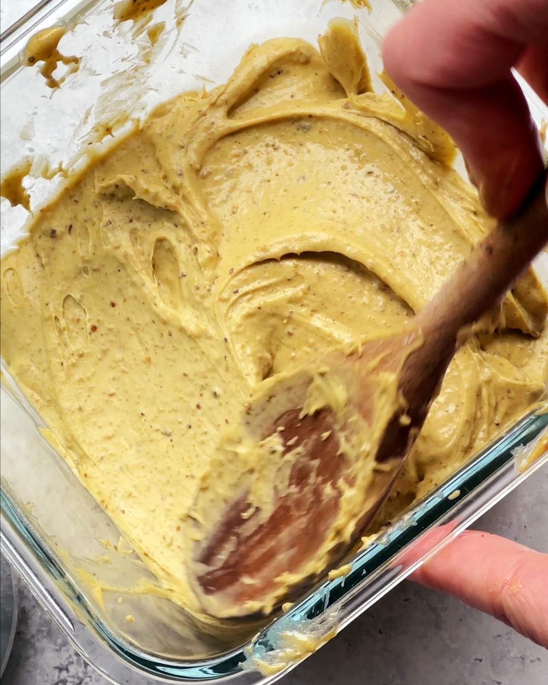 Smoothing ice cream in a freezer container with a spoon.