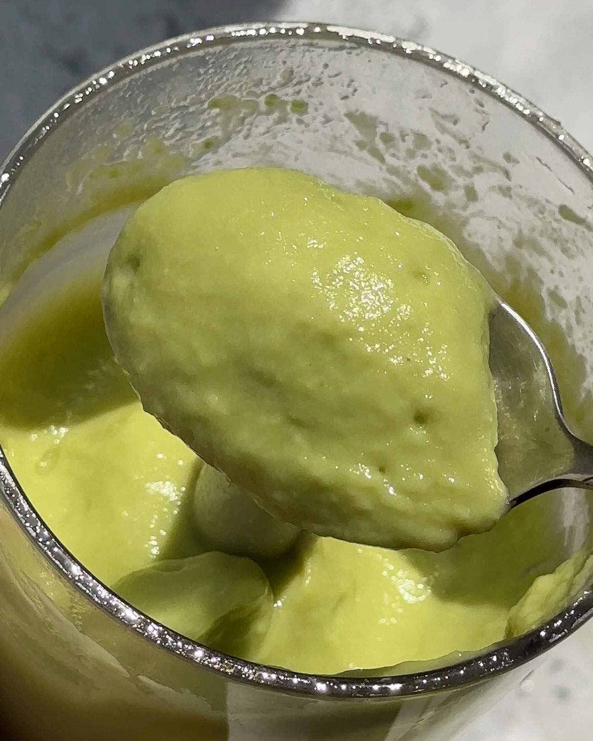 Smooth Avocado crema on a spoon.
