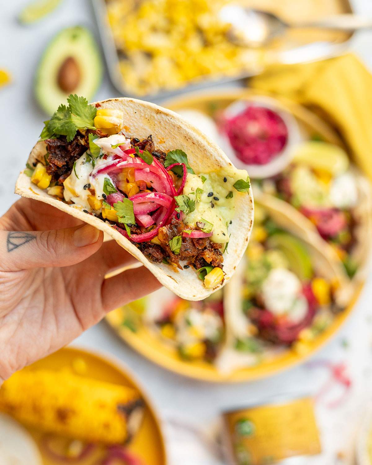 A hand holding a jackfruit taco.
