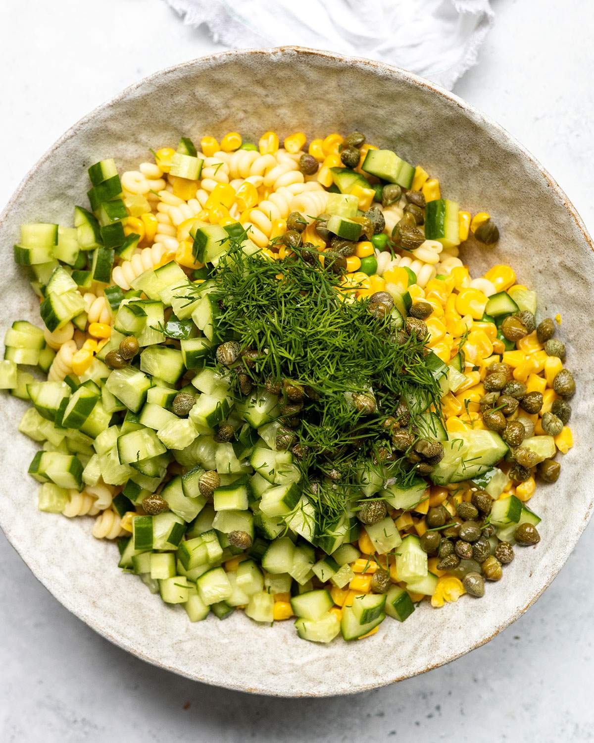 Ingredients for vegan tuna pasta salad in a large bowl before mixing.