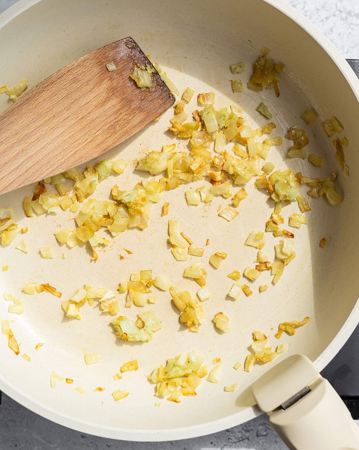 Sautéed onion and garlic in a skillet.