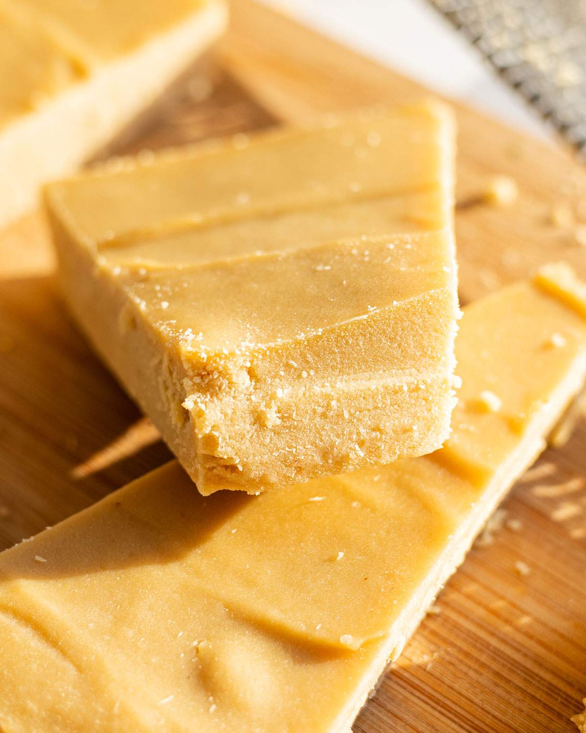 A wedge of vegan parmesan cheese shown up close.