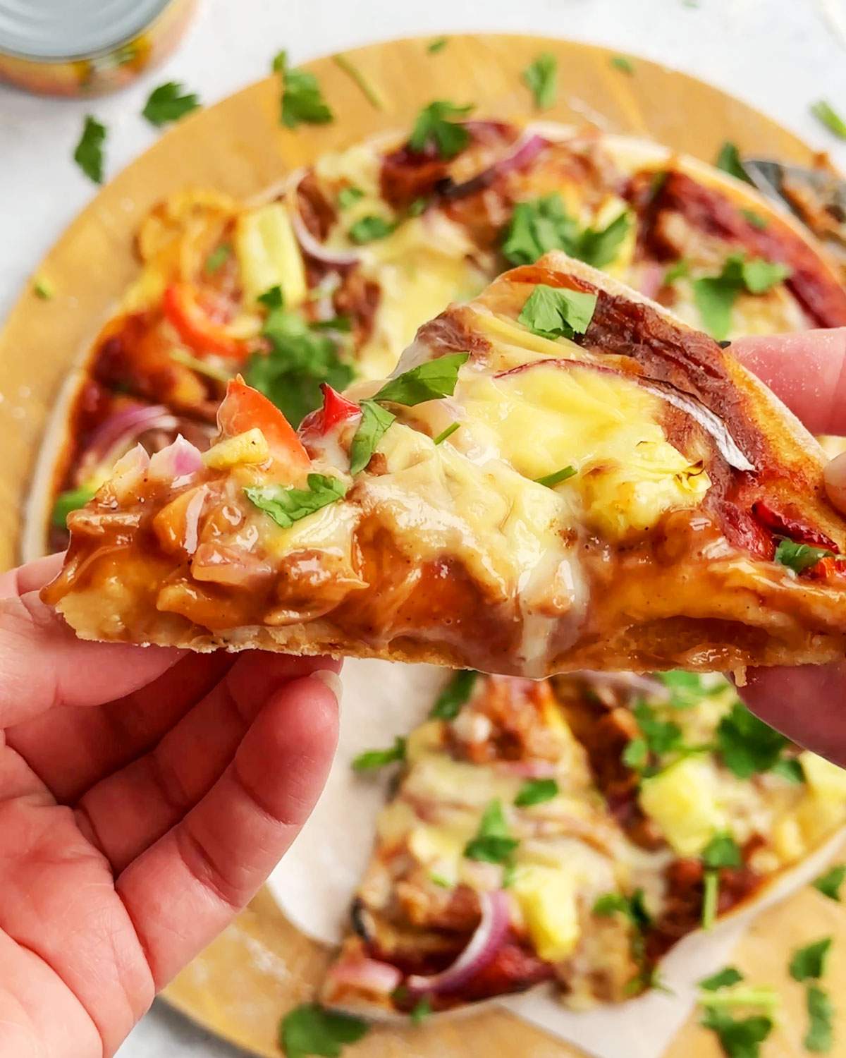 A slice of vegan bbq chicken pizza.