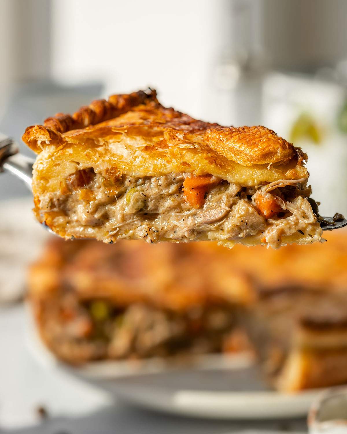 A slice of vegan chicken pot pie seen from the side.