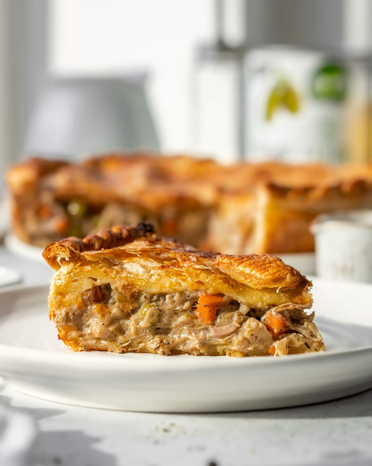 A slice of vegan chicken pot pie on a serving plate.