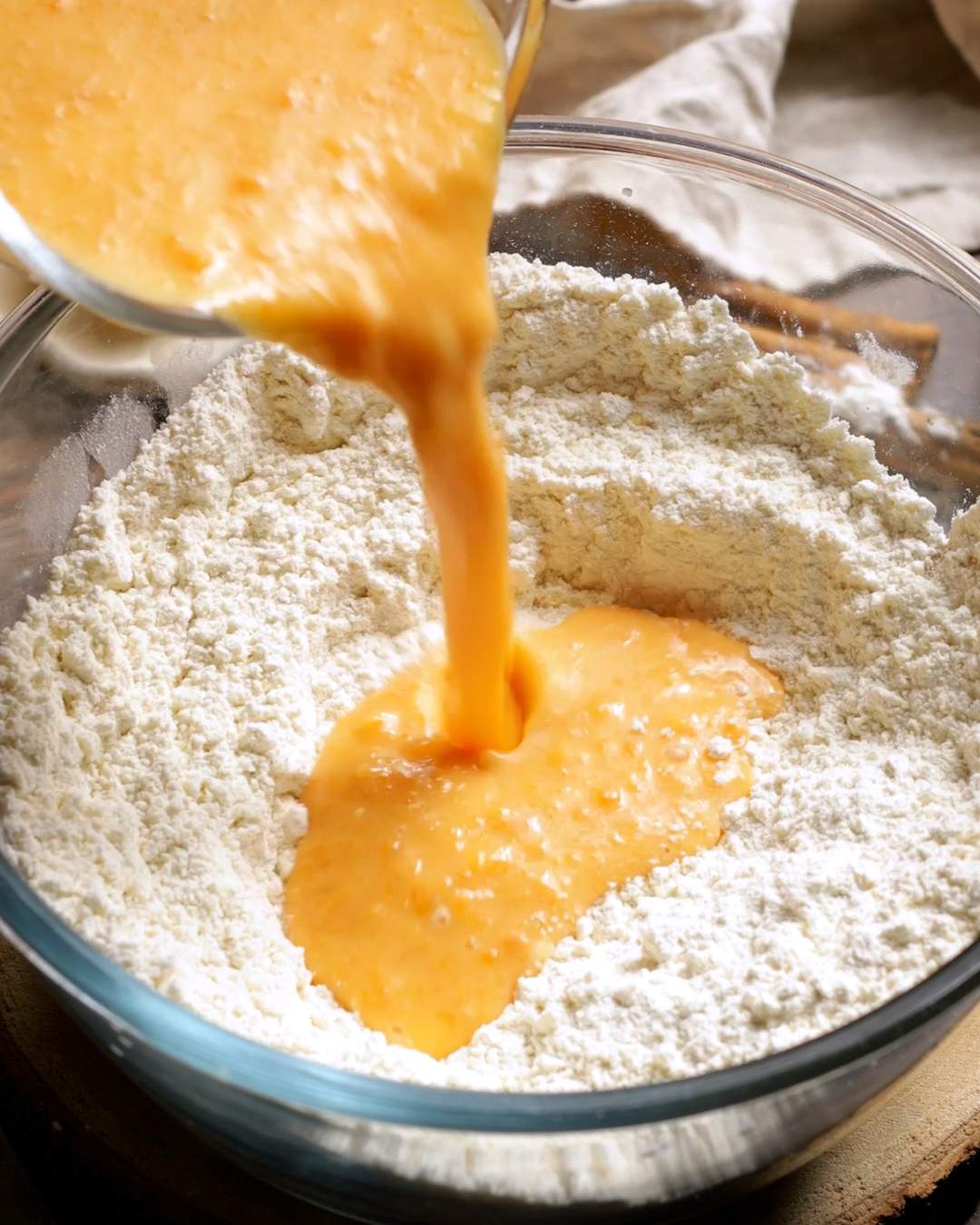 Pouring the wet ingredients into the dry ingredients.