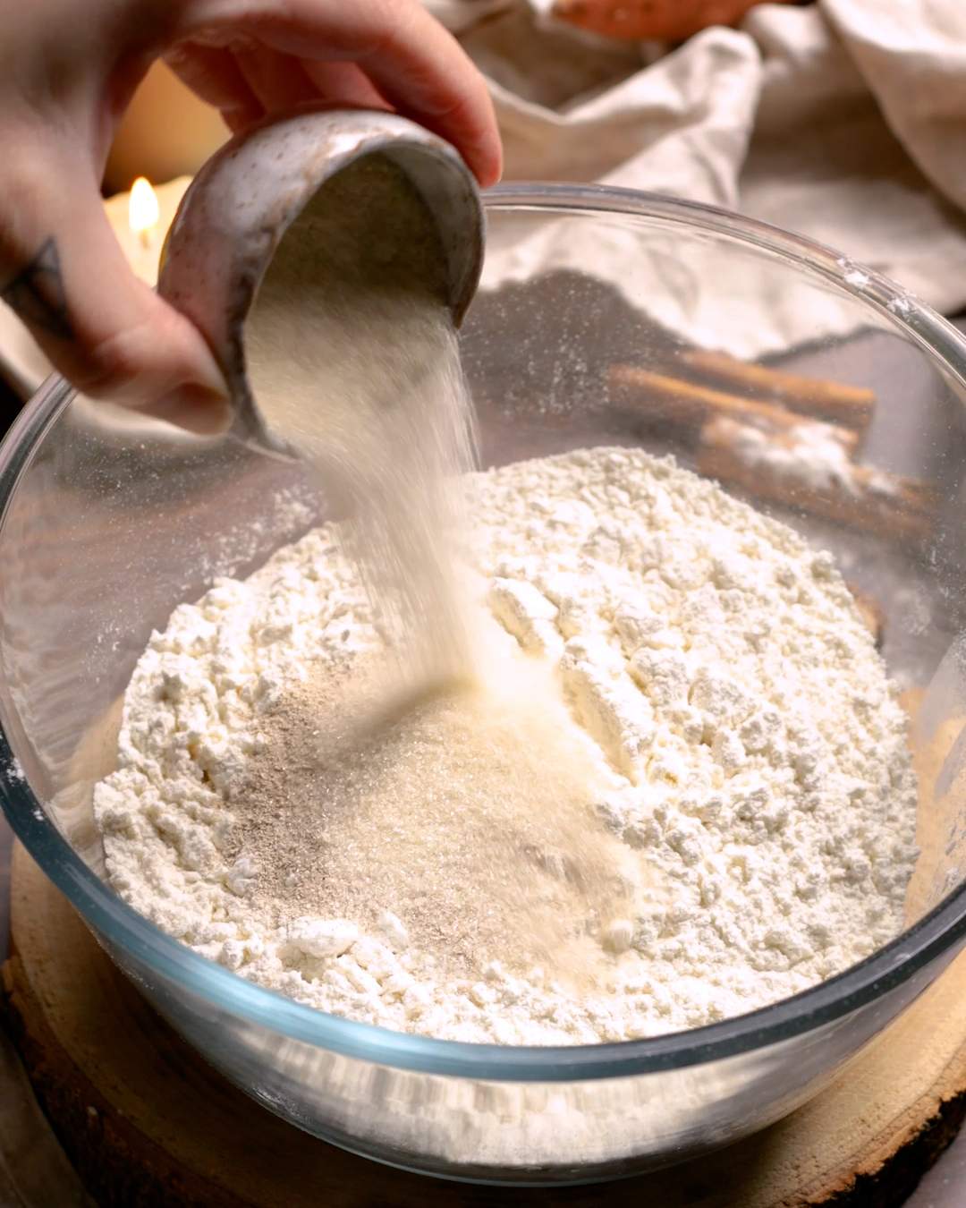 Adding active dry yeast to a bowl with flower.