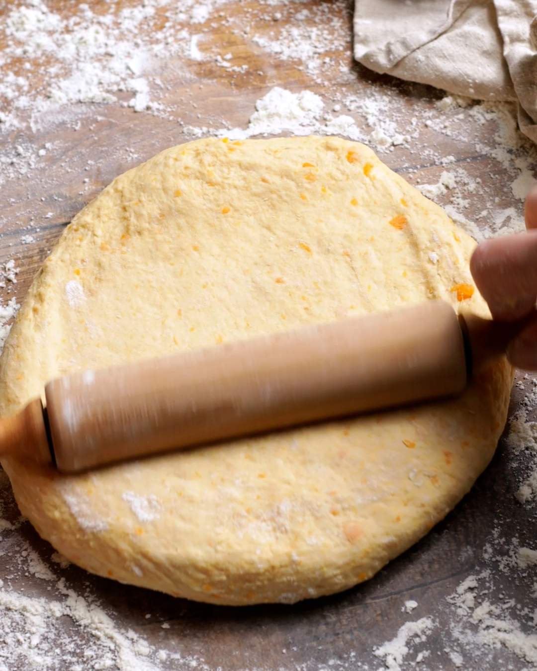 Rolling out sweet potato cinnamon roll dough.