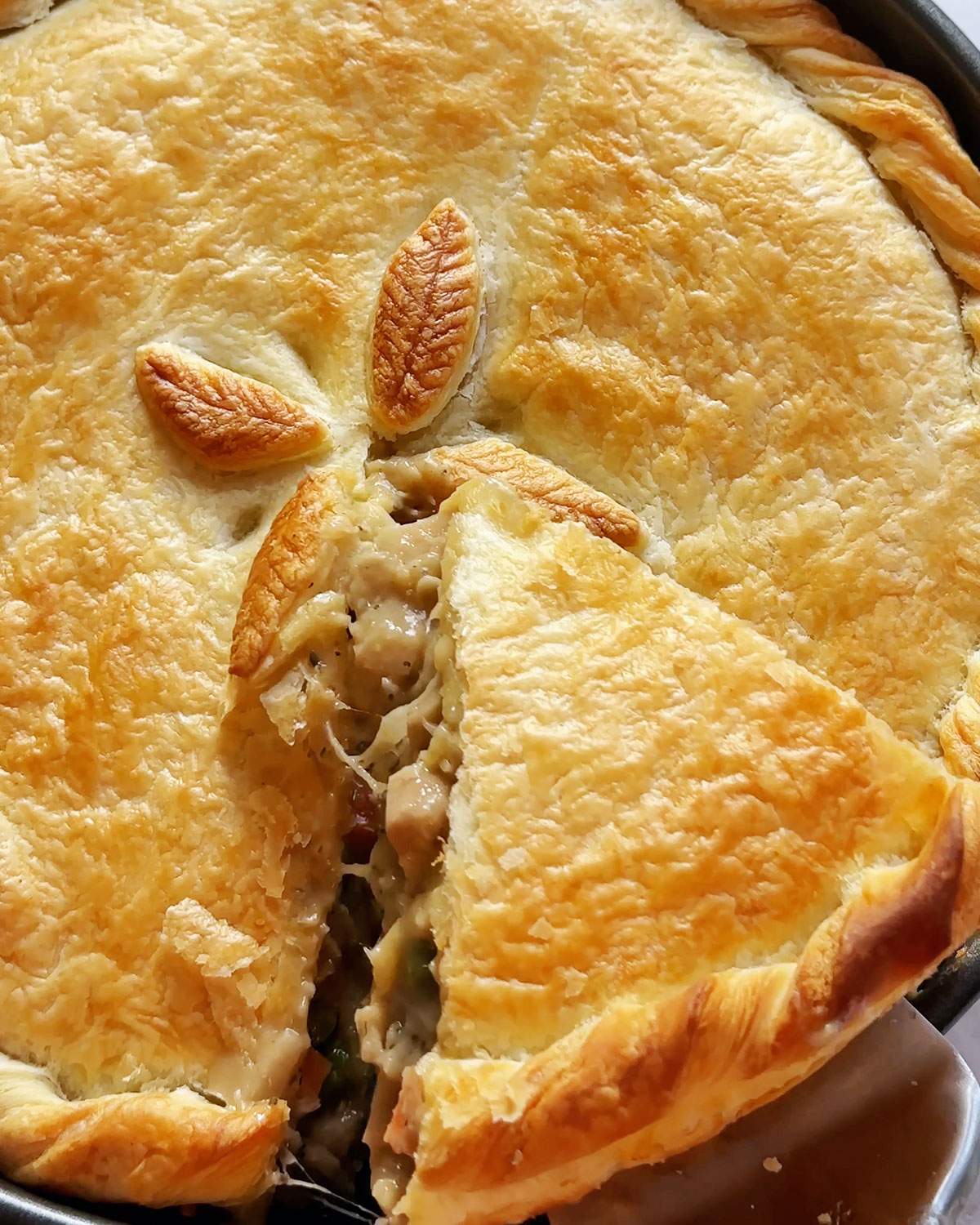 Lifting a slice of pot pie.