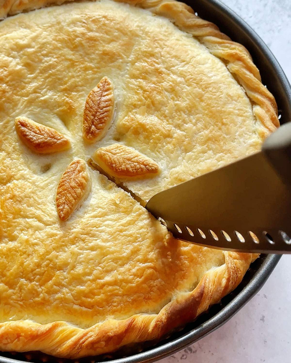 Slicing baked pot pie.