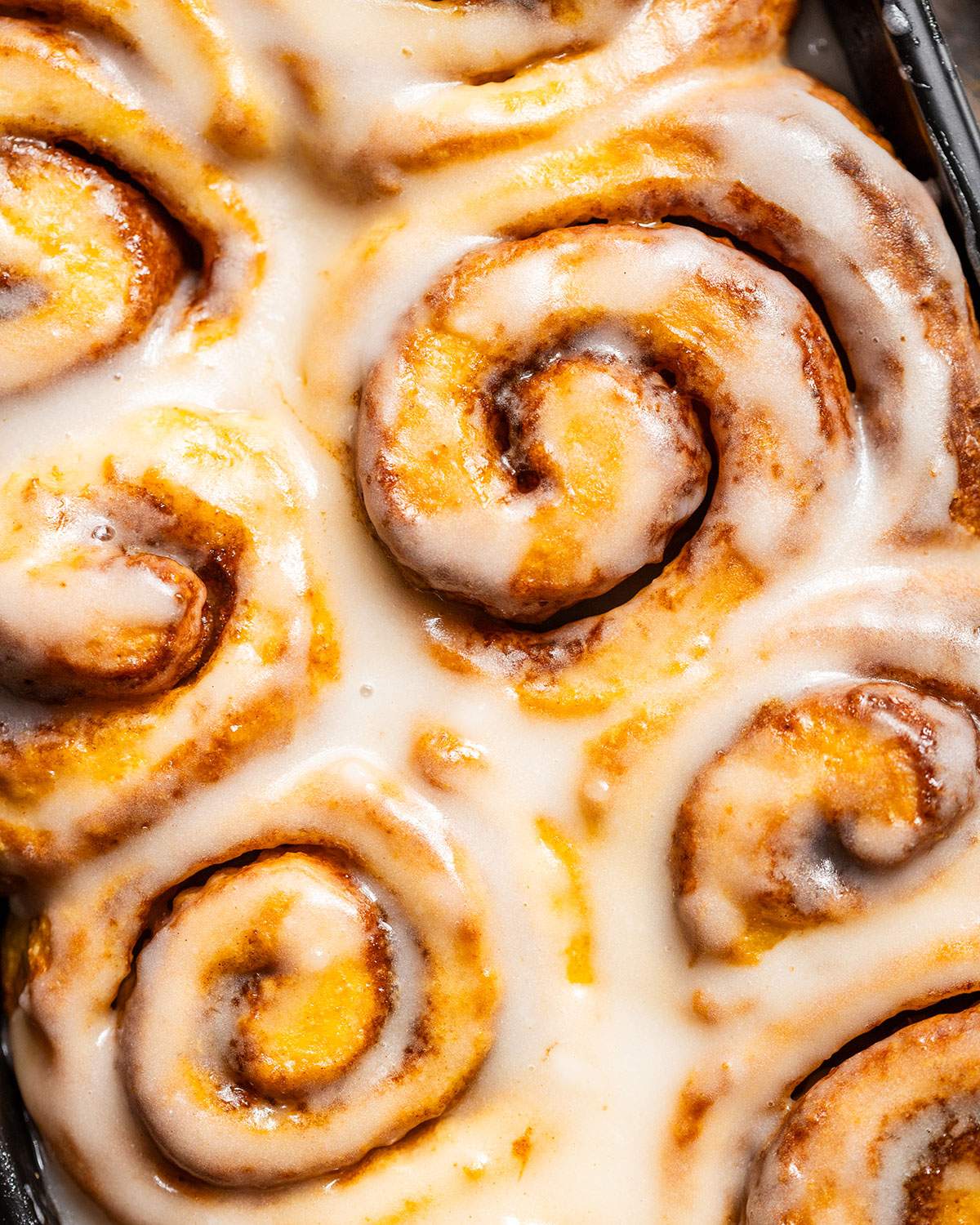 Glazed vegan cinnamon rolls up close.