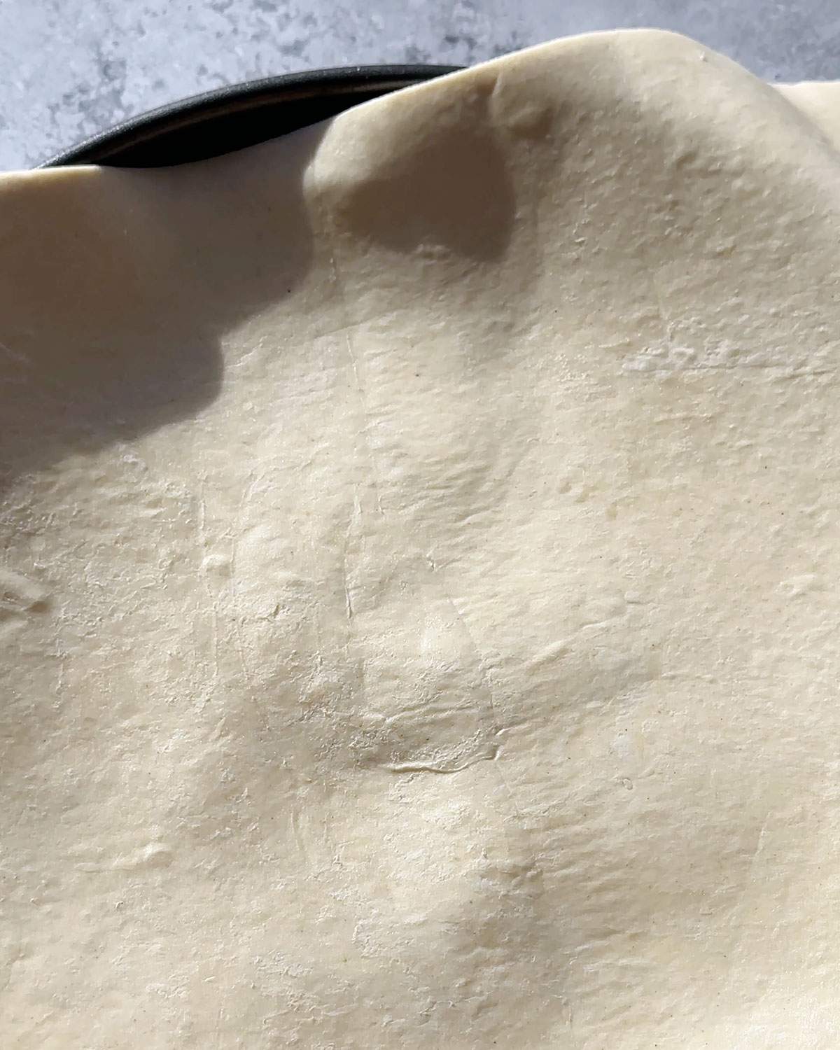 Puff pastry sheet on top of the pie pan.