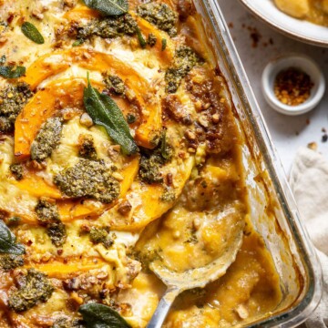 A serving spoon in a casserole dish.