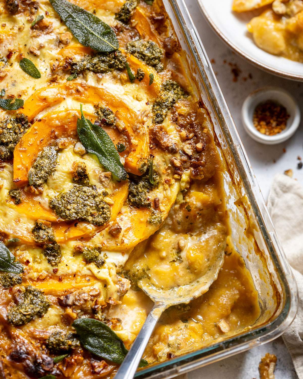 A serving spoon in a casserole dish.