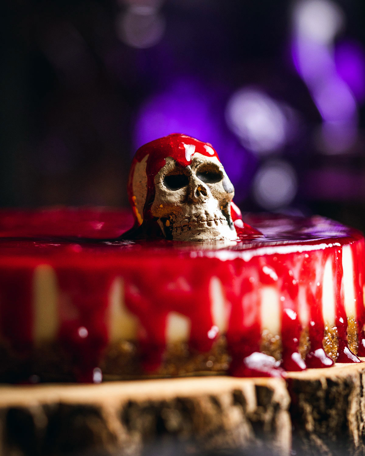 A spooky skull decoration on top of a Halloween Cheesecake.