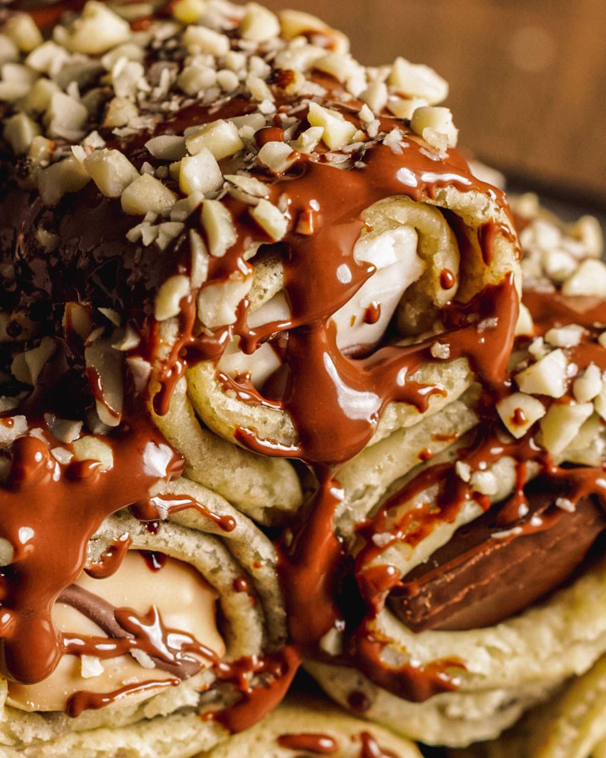 Stuffed crepe rolls up close with a drizzle of chocolate.