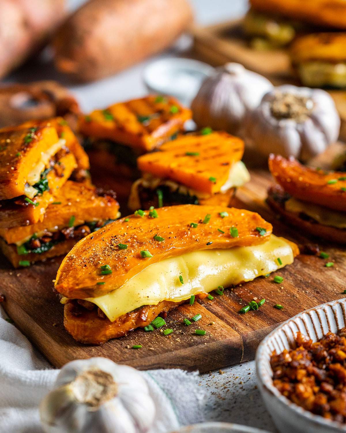 Sweet potato sandwiches on a wooden board.