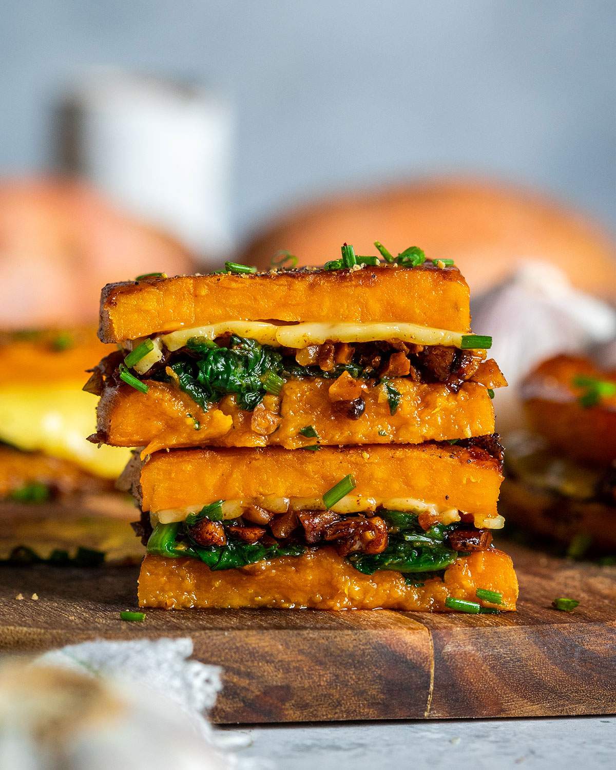 Two sweet potato grilled cheese sandwiches stacked.