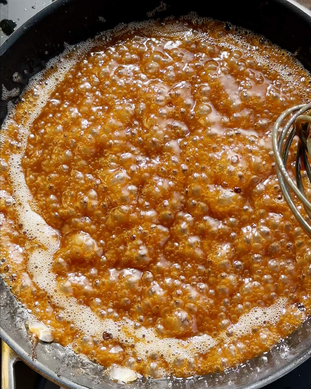 Bubbling toffee sauce in a pan.