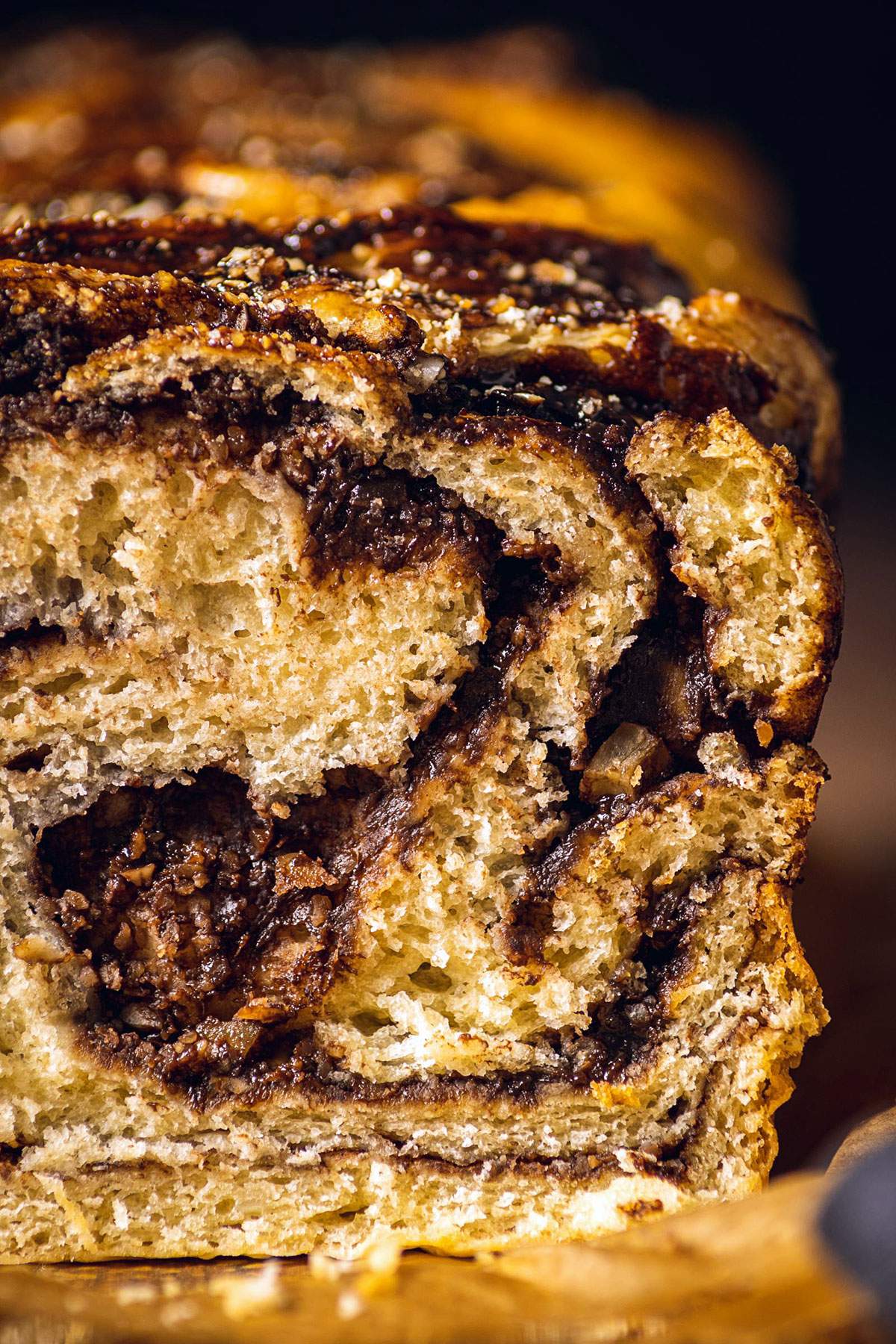 A cut open babka displaying swirly layers of chocolate in the soft dough.