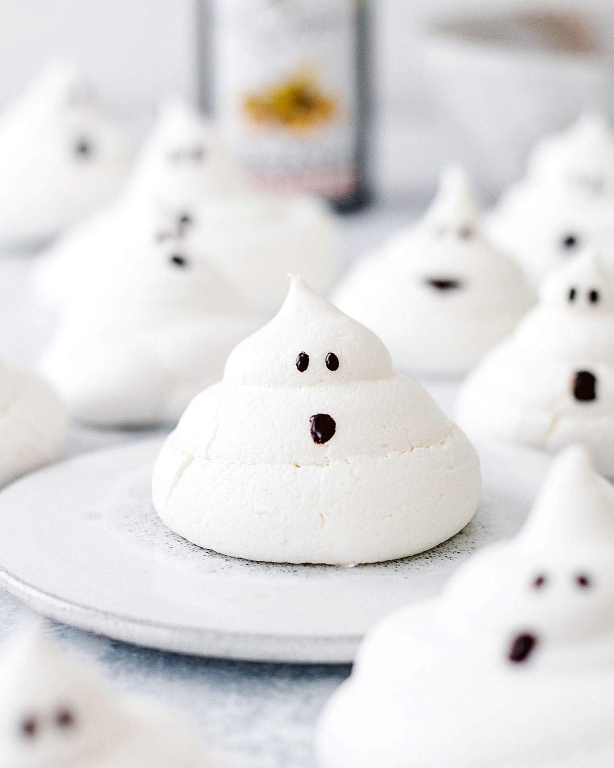 Ghost-shaped meringue with a cute face drawn on.