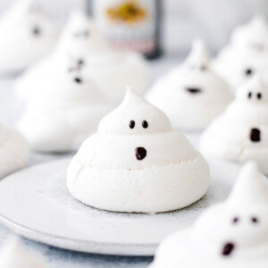 Cute meringue ghost shape with a drawn face on a small plate.