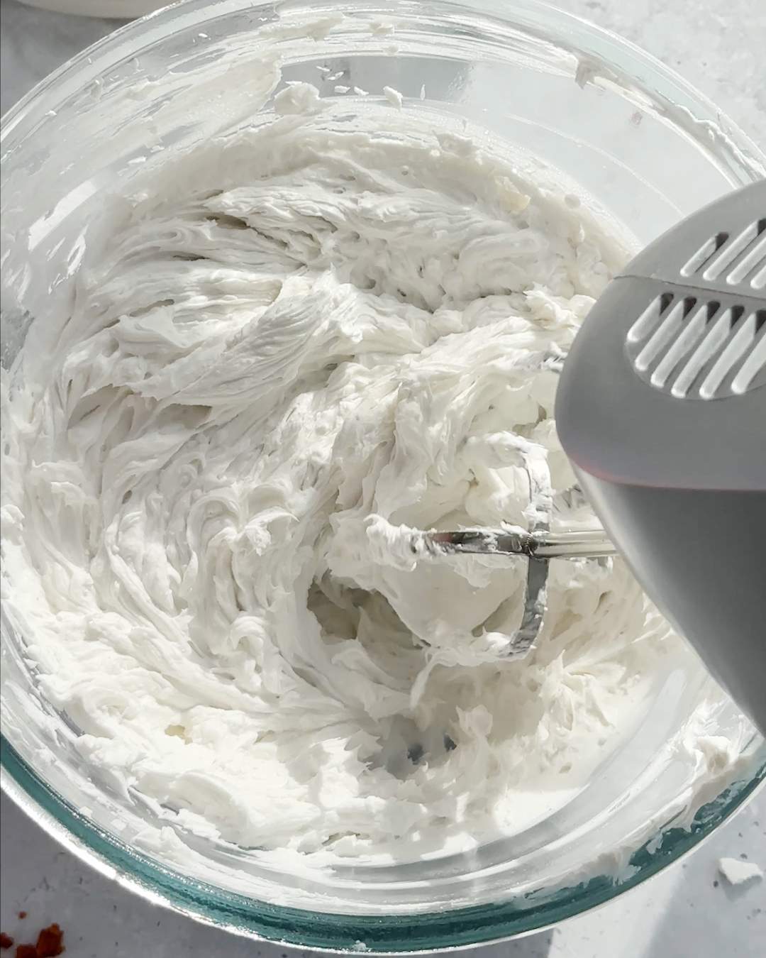 Whipped oat cream in a mixing bowl.
