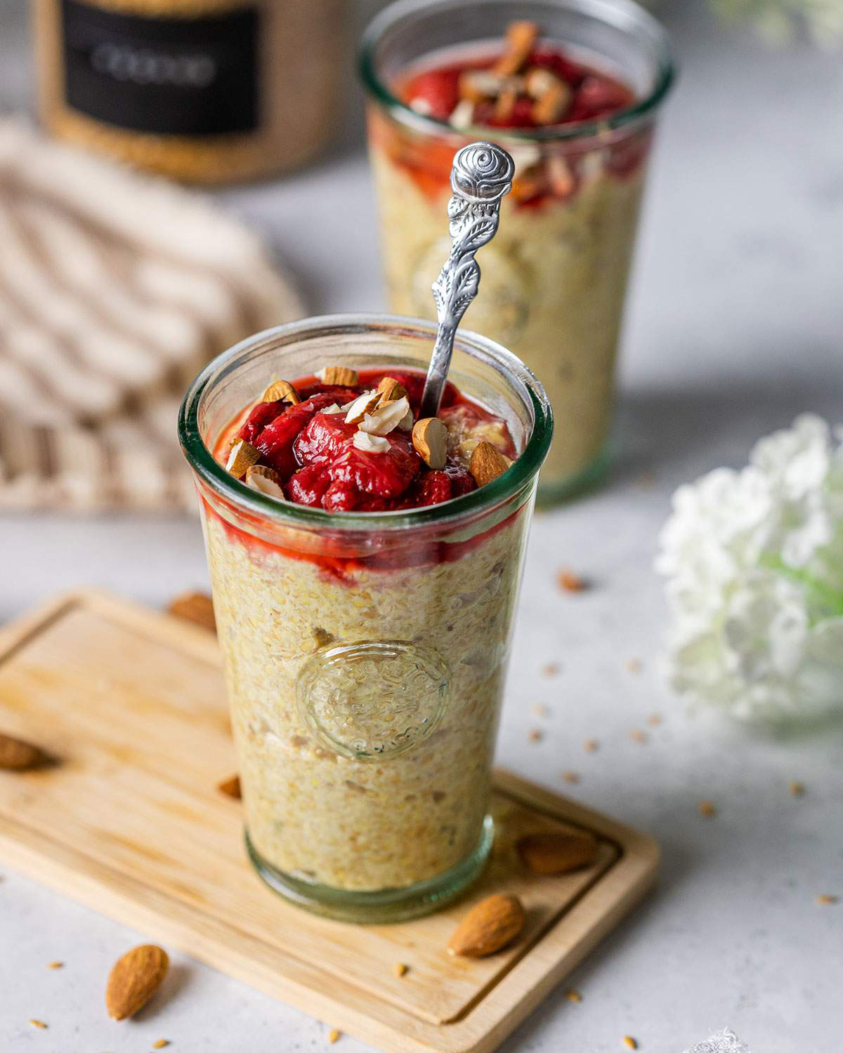 A tall glass with flaxseed pudding and stewed berries on top.