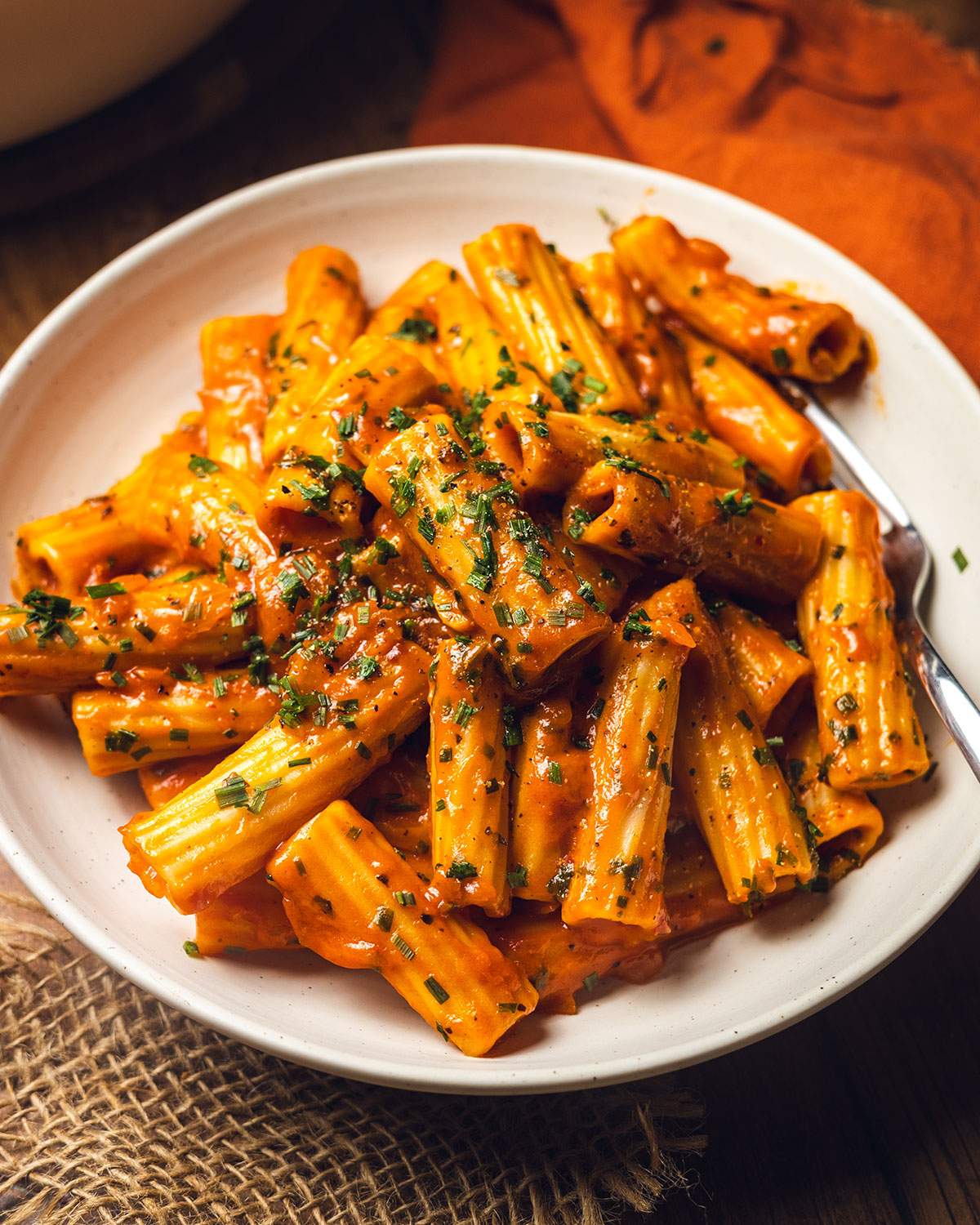 Creamy rigatoni pasta in a serving bowl.