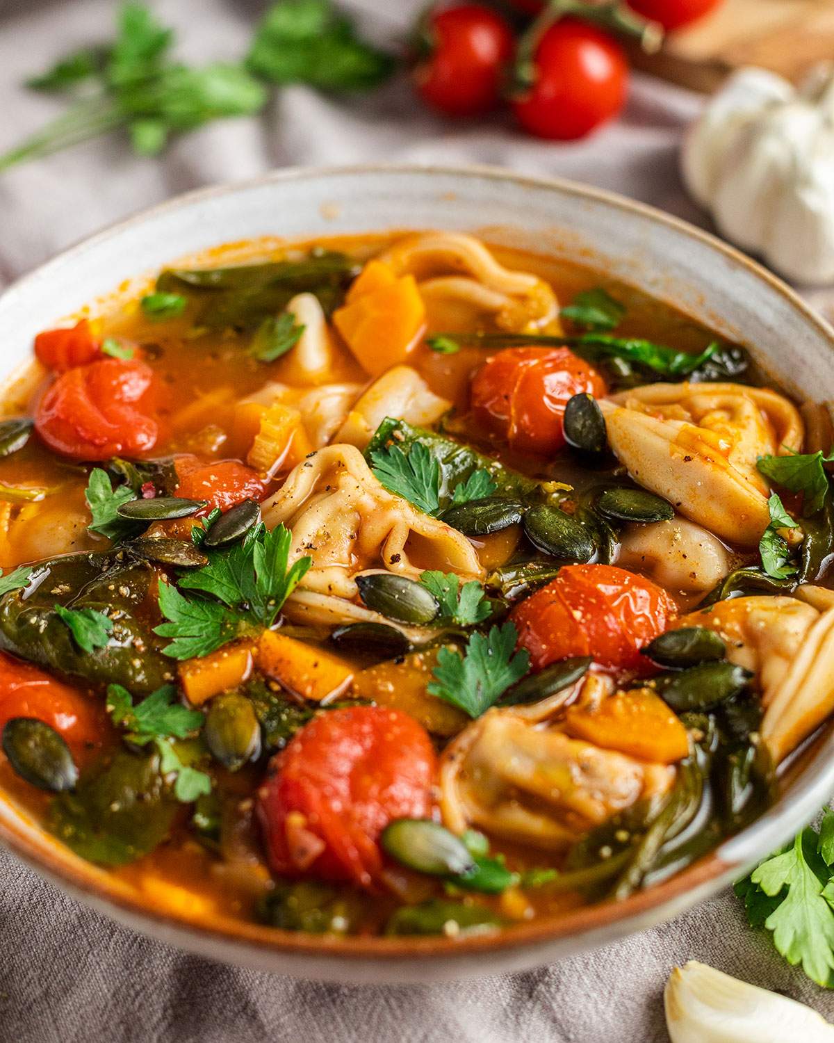 A bowl of vegan tortellini soup.