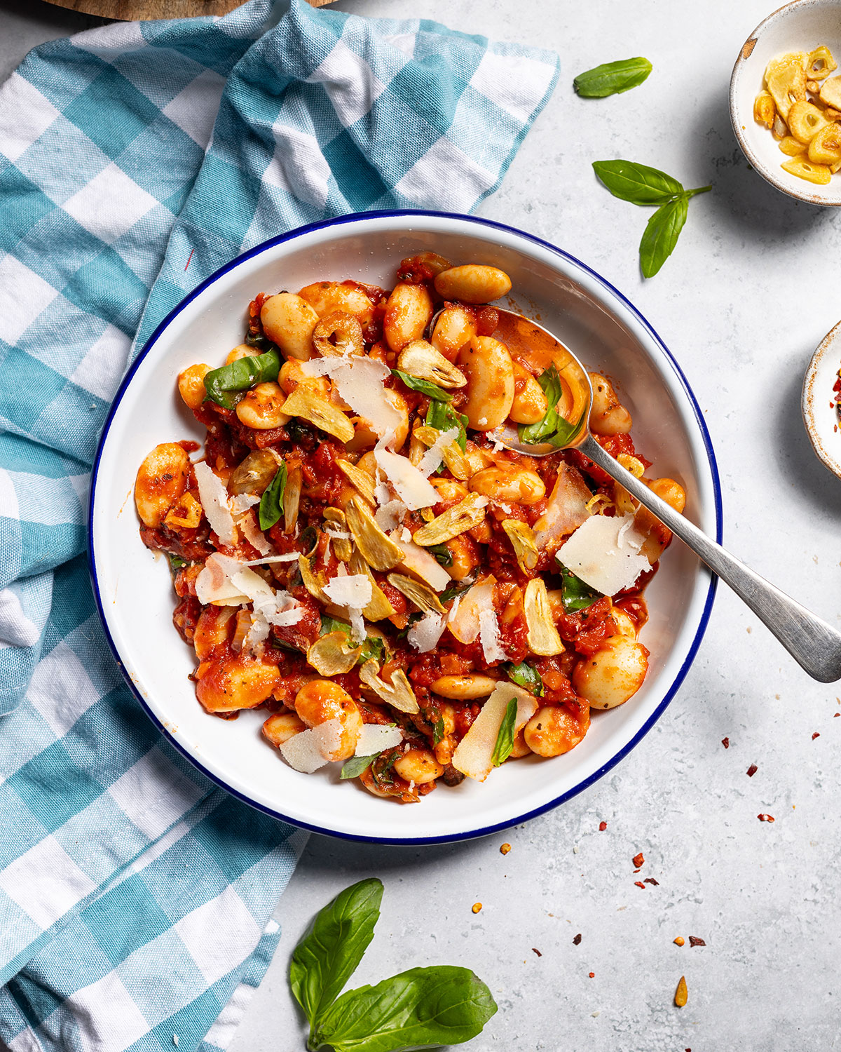 Spicy arrabbiata beans on a plate with a spoon.