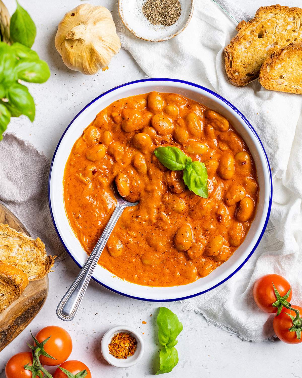 Creamy Beans Alla Vodka on a plate with a spoon.