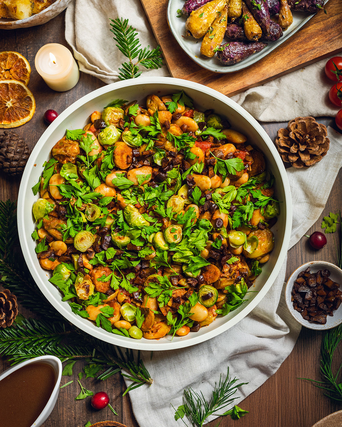Caramelized brussels sprouts in a skillet on the dinner table with fresh herbs on top.