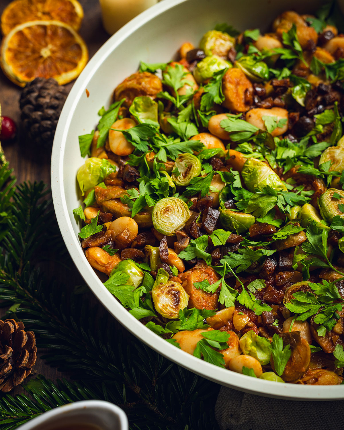 Caramelized brussels sprouts with chestnuts and beans in a skillet.