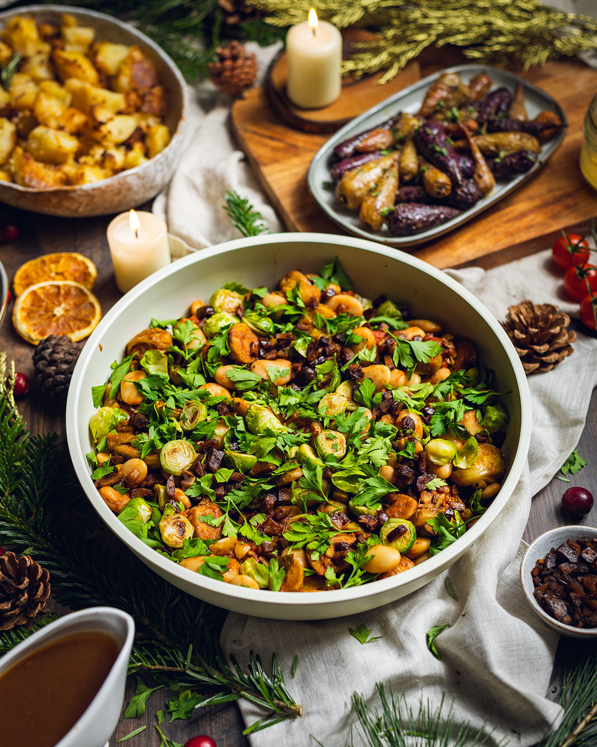 Caramelized brussels sprouts in a skillet on the dinner table with fresh herbs on top.
