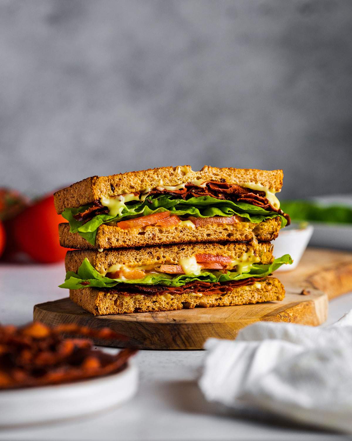 A carrot BLT sandwich on a cutting board.