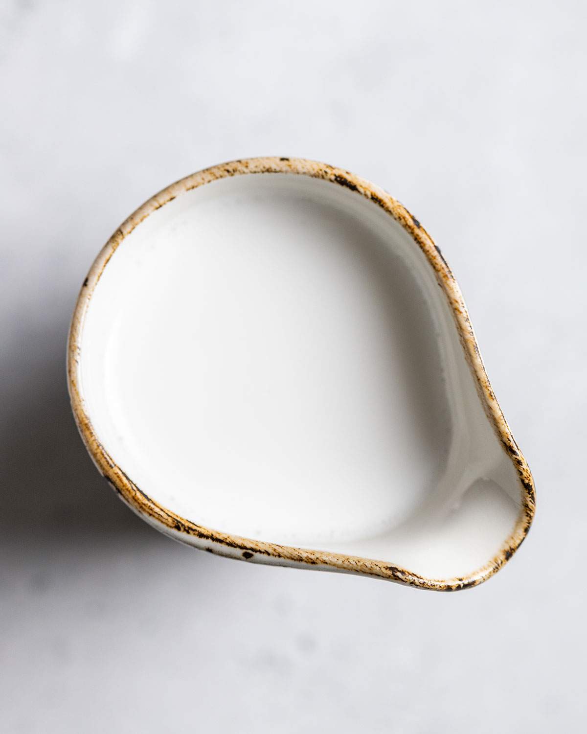 Coconut cream in a jug from above.
